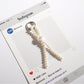 Keypus beaded bow keychain with pink and white beads shown from above