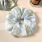 Gifty natural pure blue scrunchie styled in a ponytail on a model