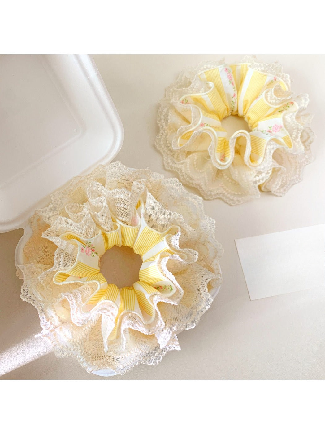Close-up of yellow lace scrunchie showing delicate fabric texture