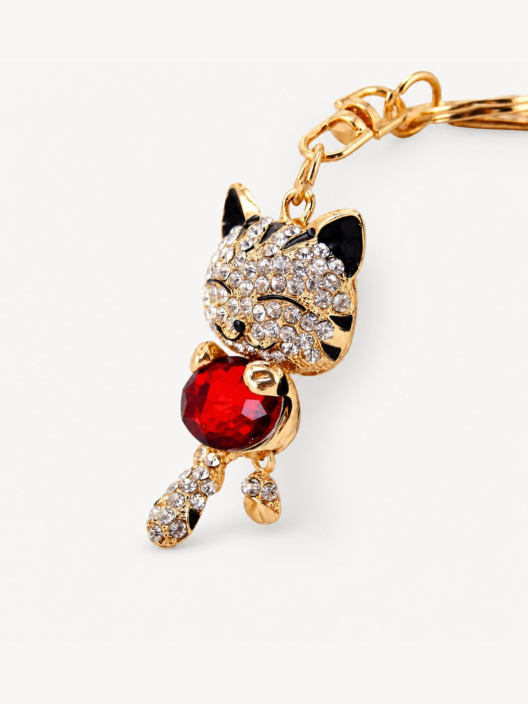 Red faceted cat keychain on neutral background