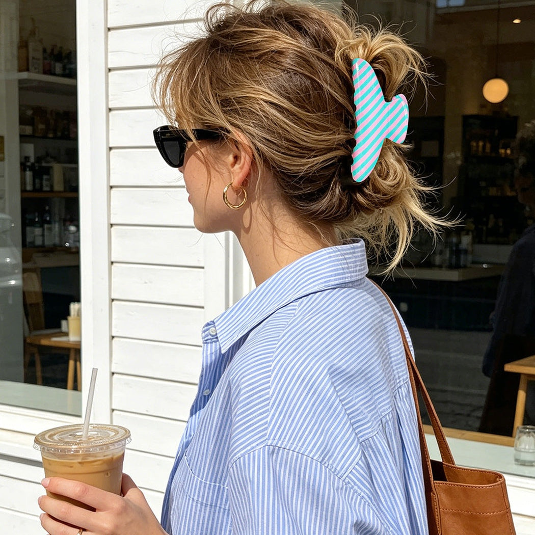 Blue and white striped hair claw clip in an updo