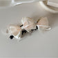 Beau Sweet Bow Banana Clip with a textured fabric bow in soft beige
