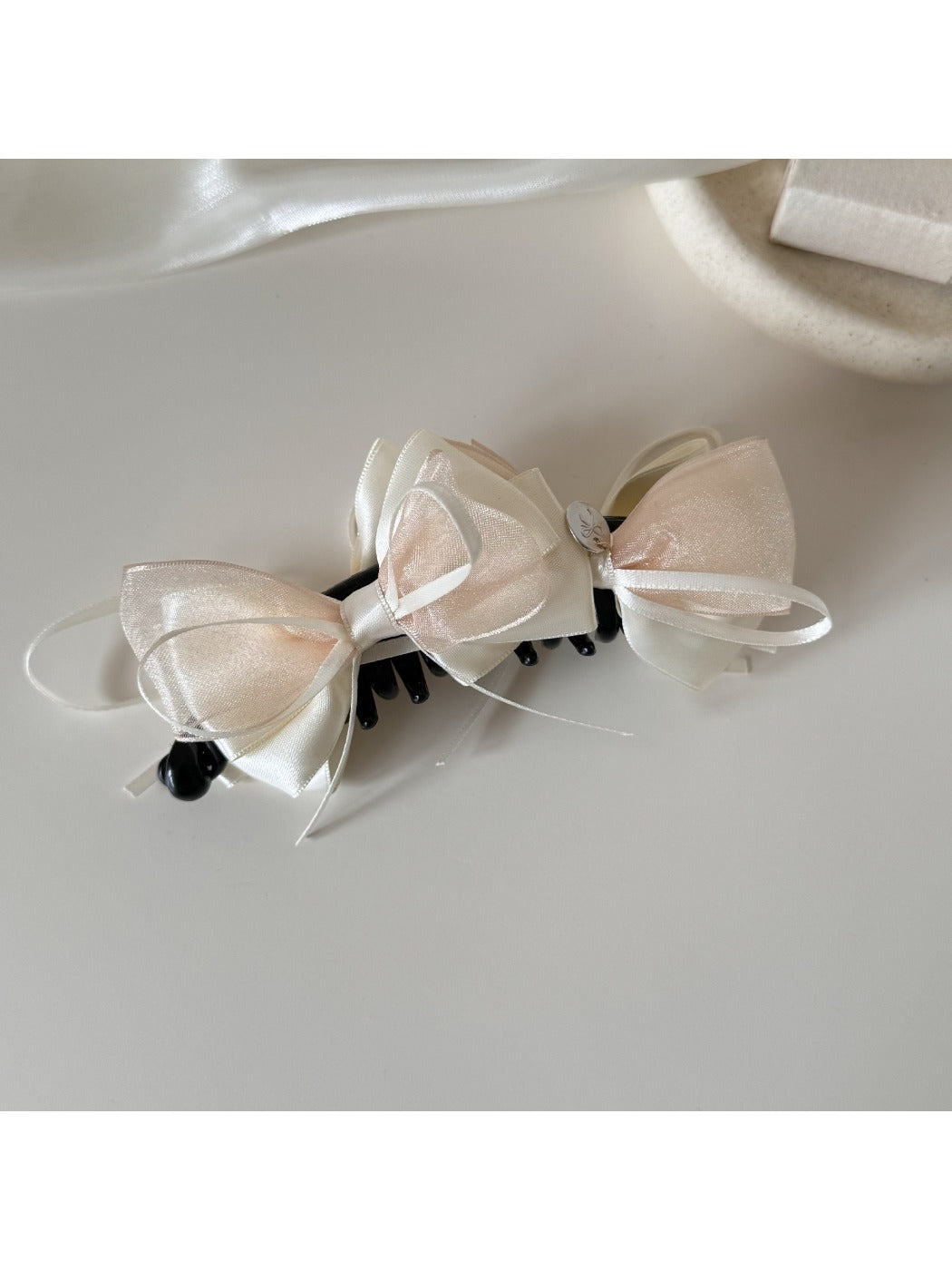 Beau Sweet Bow Banana Clip with a textured fabric bow in soft beige