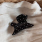 Beau puppy hair clip placed on a wooden surface showing size and pattern details