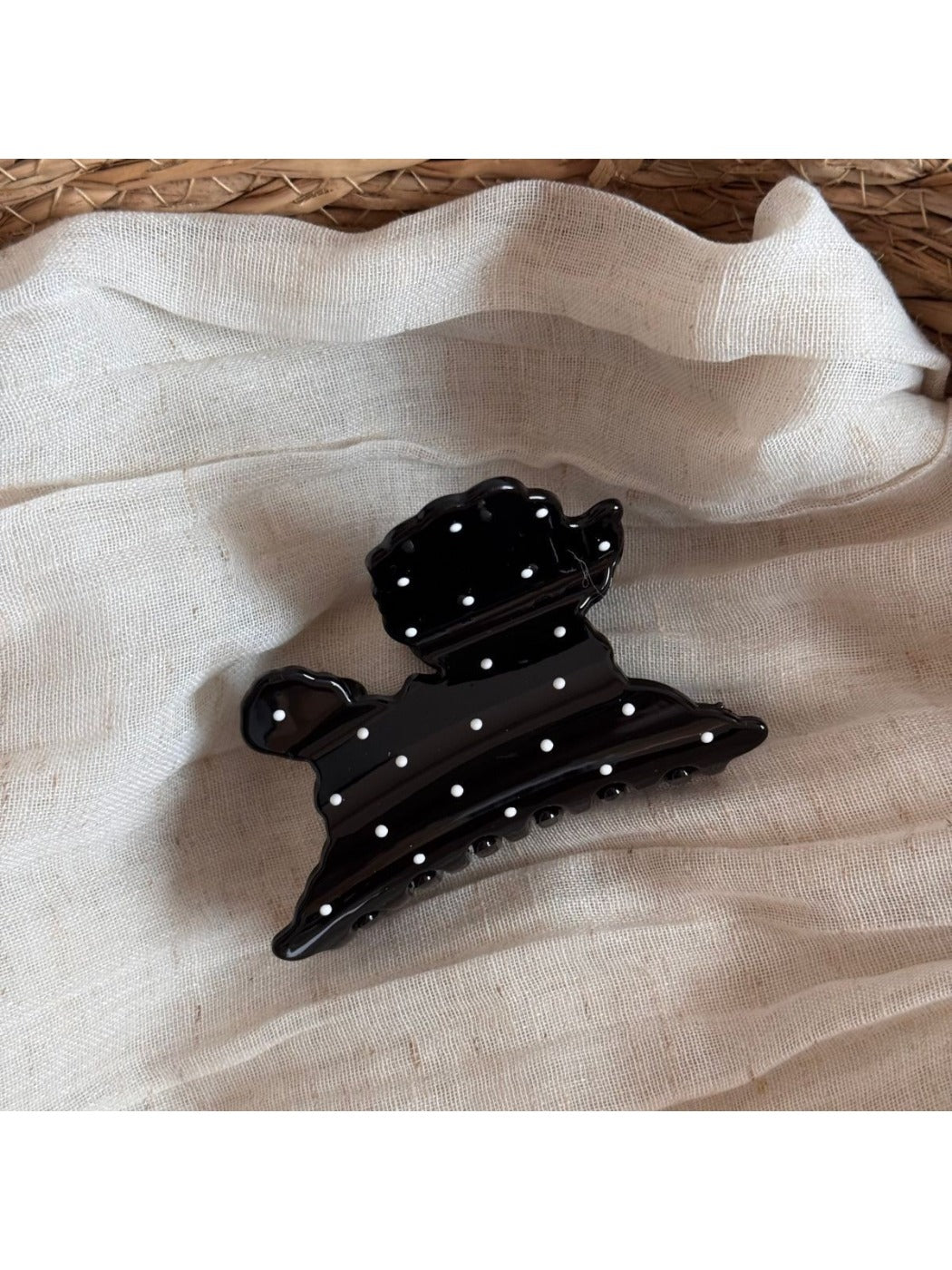 Beau puppy hair clip placed on a wooden surface showing size and pattern details