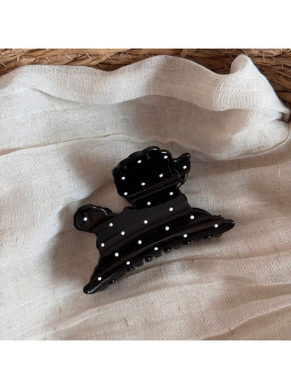 Beau puppy hair clip placed on a wooden surface showing size and pattern details