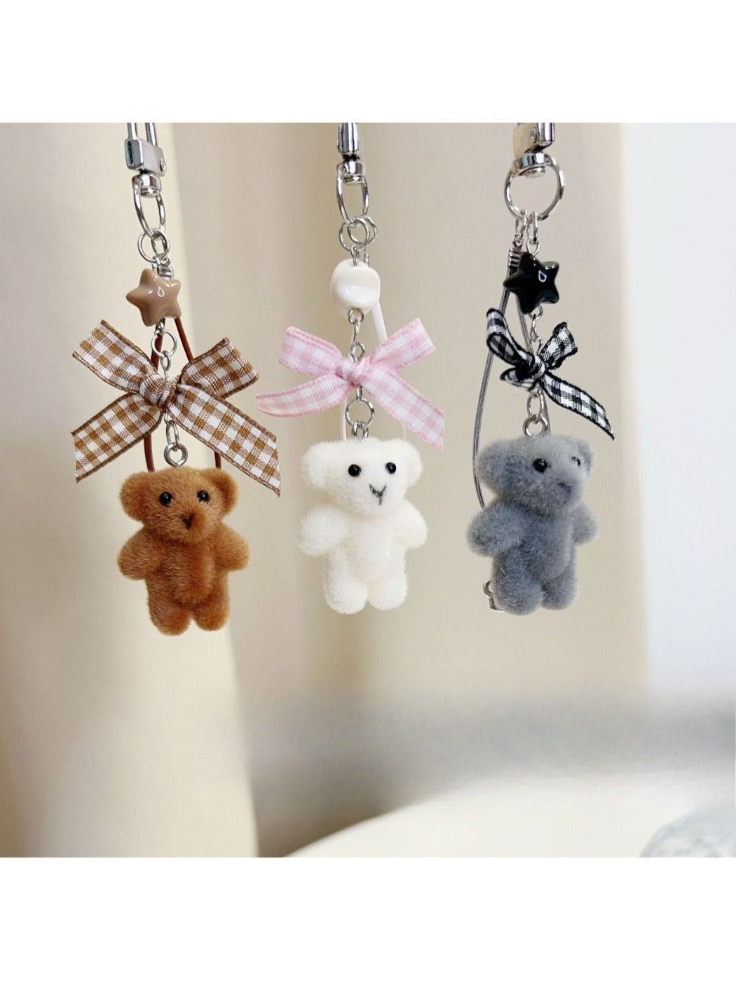 Keypus bear keychain attached to a set of keys on a wooden surface