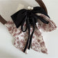 Beau Ink Wash Bow Ribbon Claw Clip with soft lighting emphasizing texture