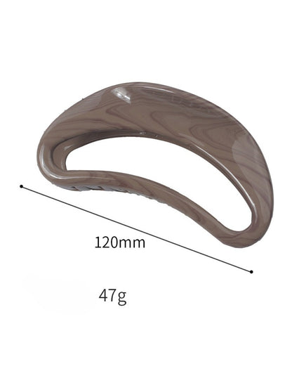Beau hair clip holding a section of blonde hair styled in a half-updo