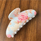 Beau colorful flower pattern hair clip photographed with natural lighting