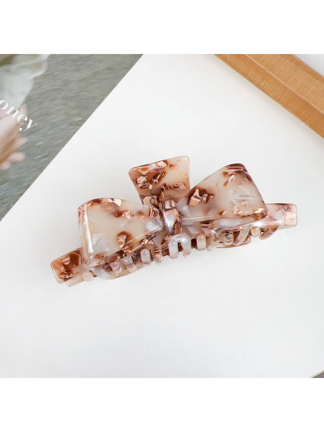 Beau bow shaped claw clip in soft pink color with smooth edges