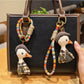 Close-up of a stylish duck charm keychain with gold-tone metal and enamel details