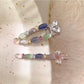 Beau sweet colorful hair clip with pastel pink, blue, and yellow petals on white background