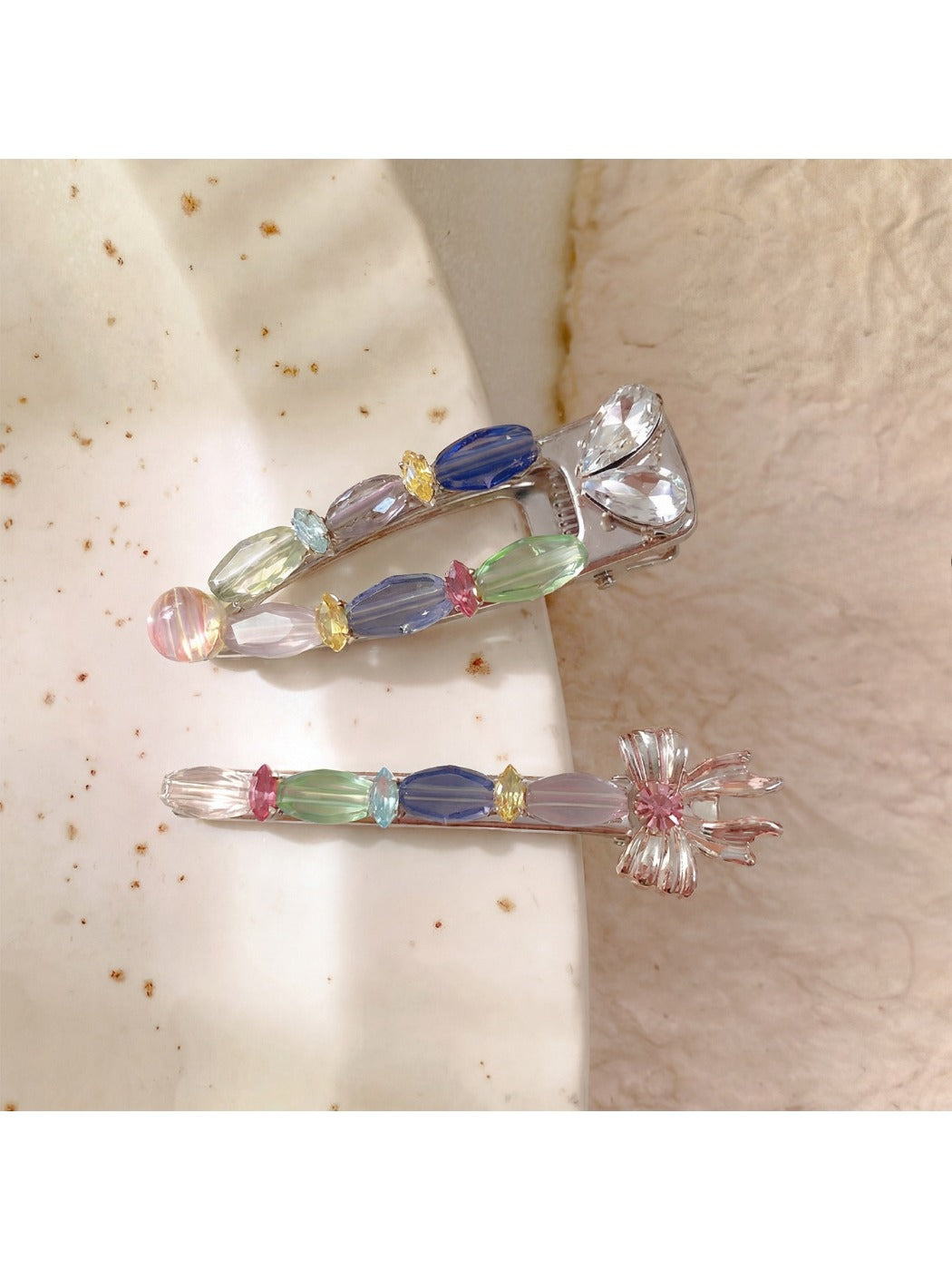 Beau sweet colorful hair clip with pastel pink, blue, and yellow petals on white background