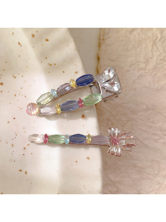 Beau sweet colorful hair clip with pastel pink, blue, and yellow petals on white background
