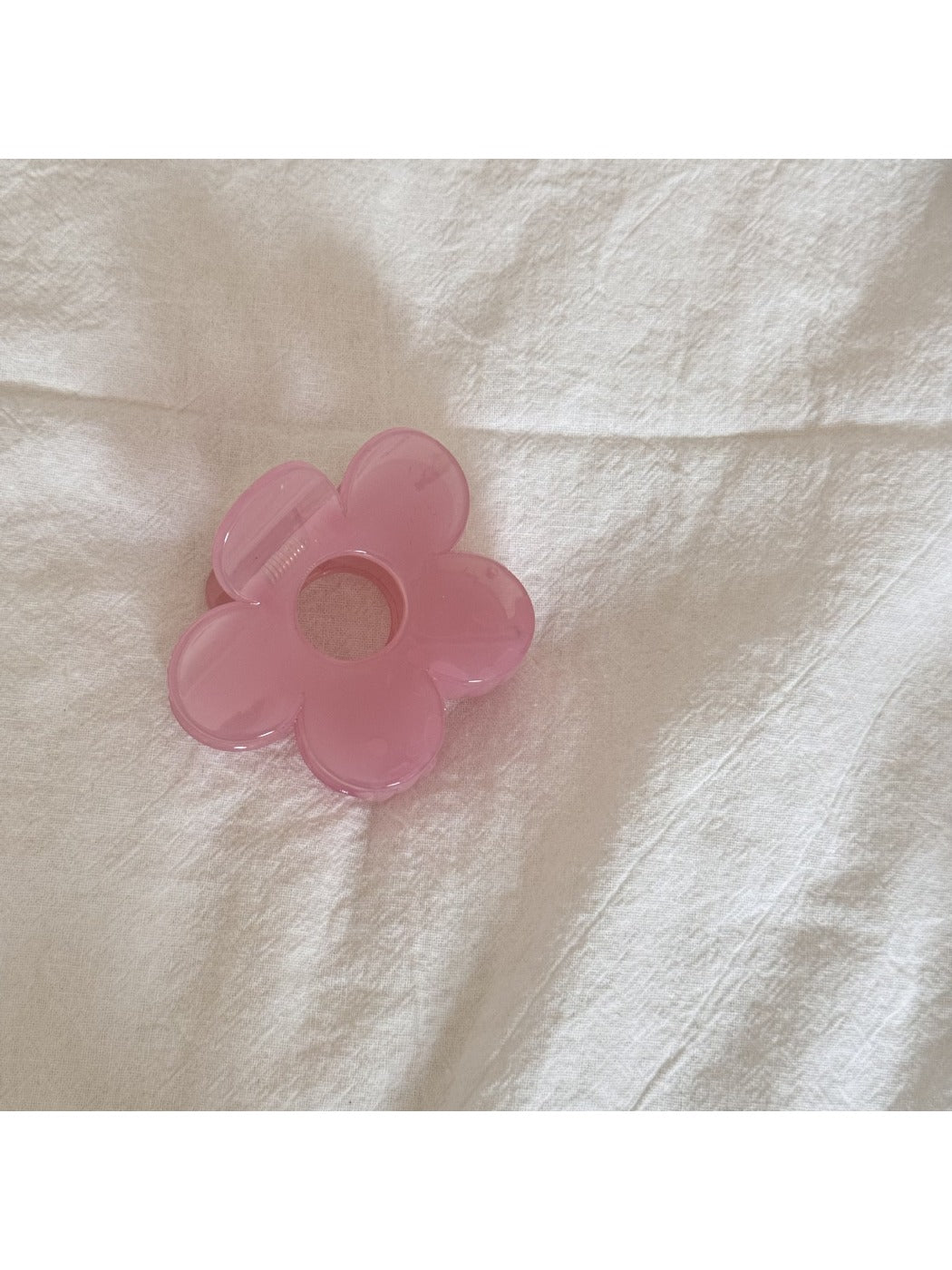 Beau flower claw clip displayed on a wooden surface