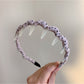 Gifty polka dot toothed comb headband styled with hair on a mannequin