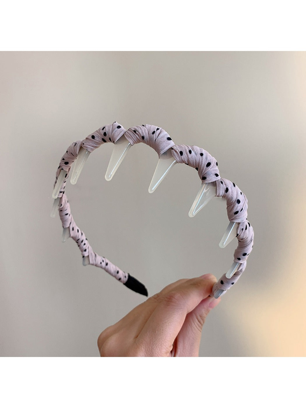 Gifty polka dot toothed comb headband styled with hair on a mannequin