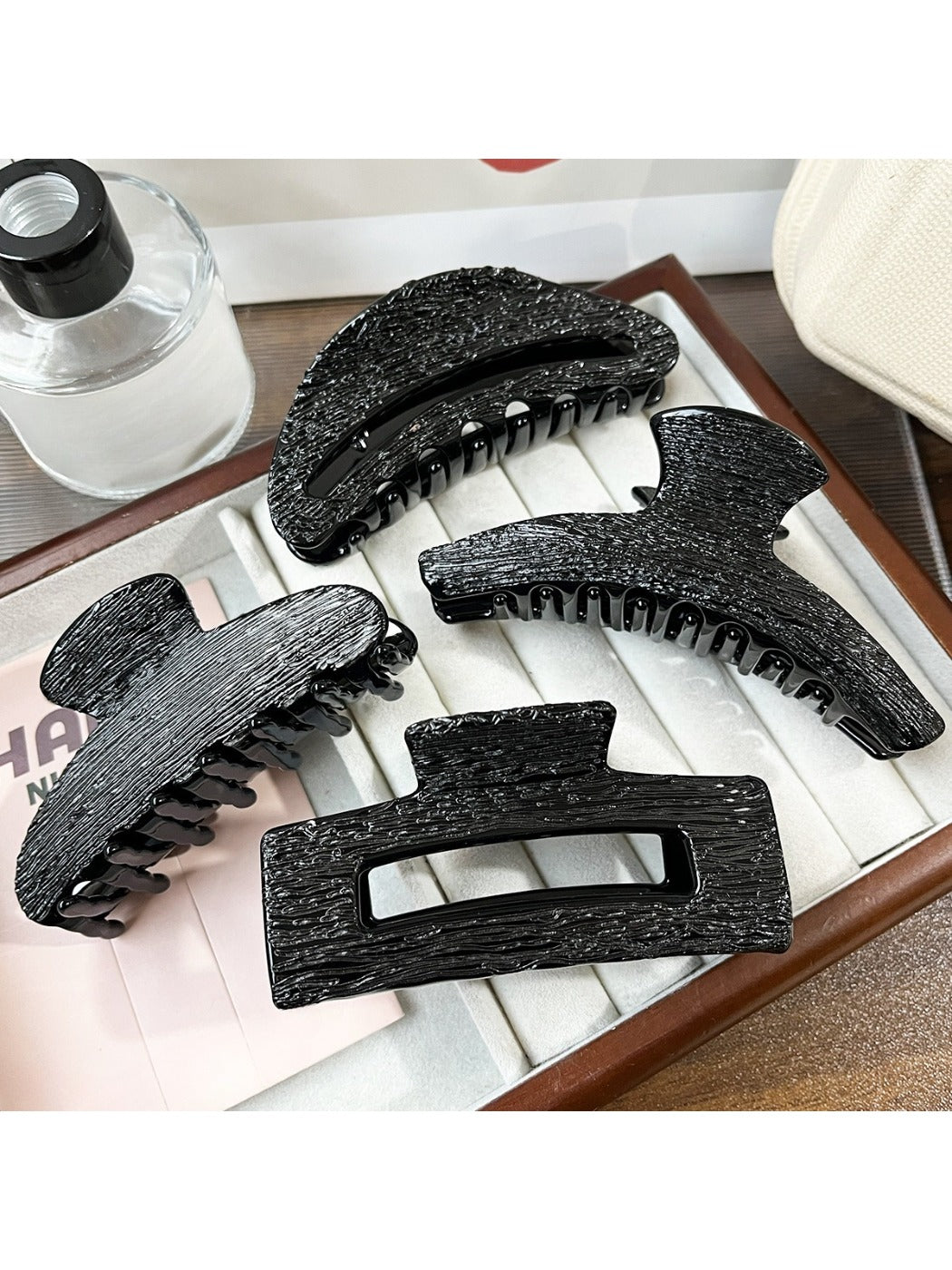 Beau black acetate claw clip on white background showing front view