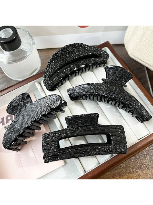 Beau black acetate claw clip on white background showing front view