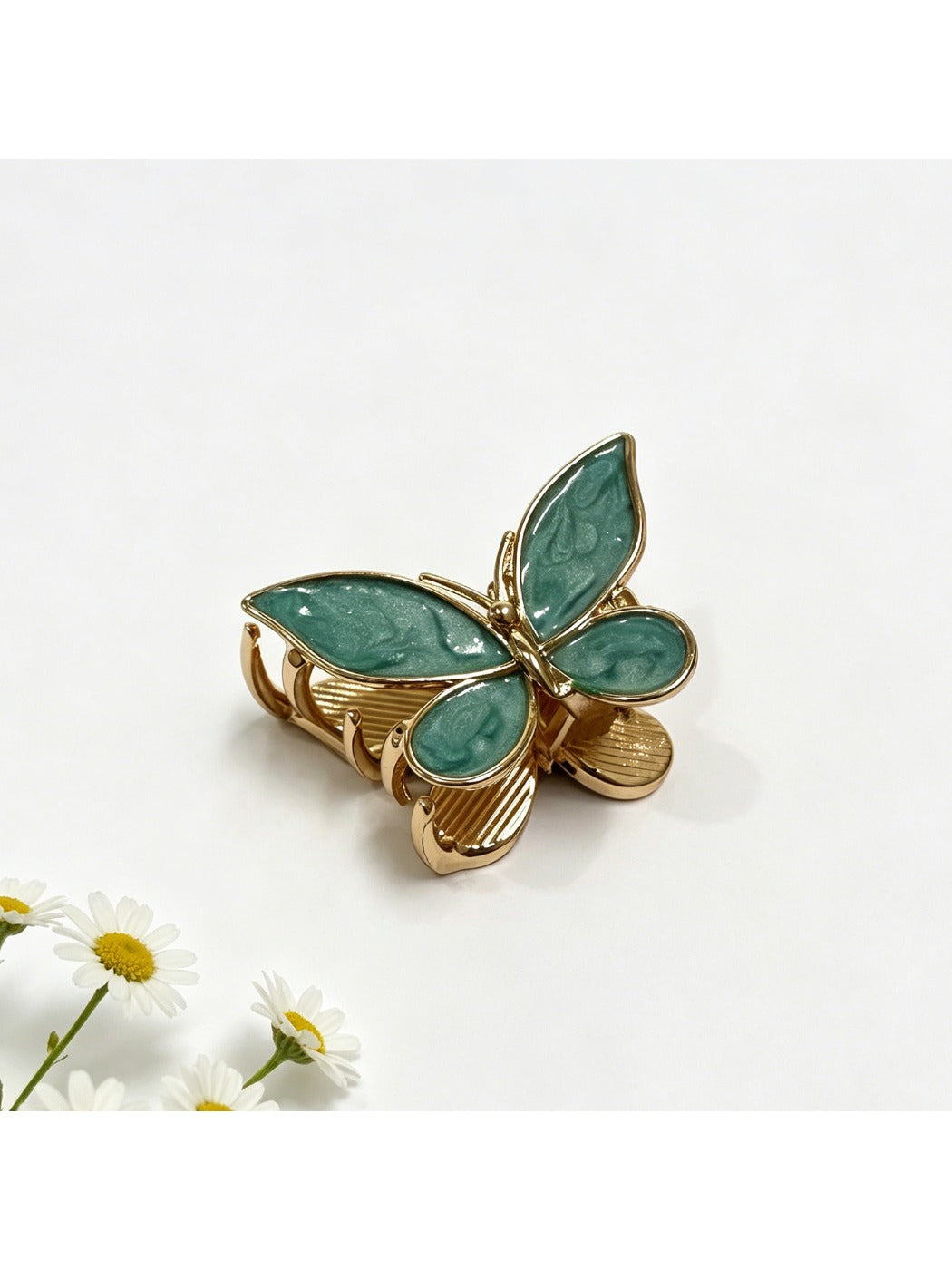 Beau butterfly hair clip in pastel blue displayed on a wooden surface