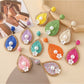 Close-up of Earedge chic teardrop drop earrings on white background