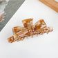 Beau claw clip used to hold thick hair in a casual hairstyle