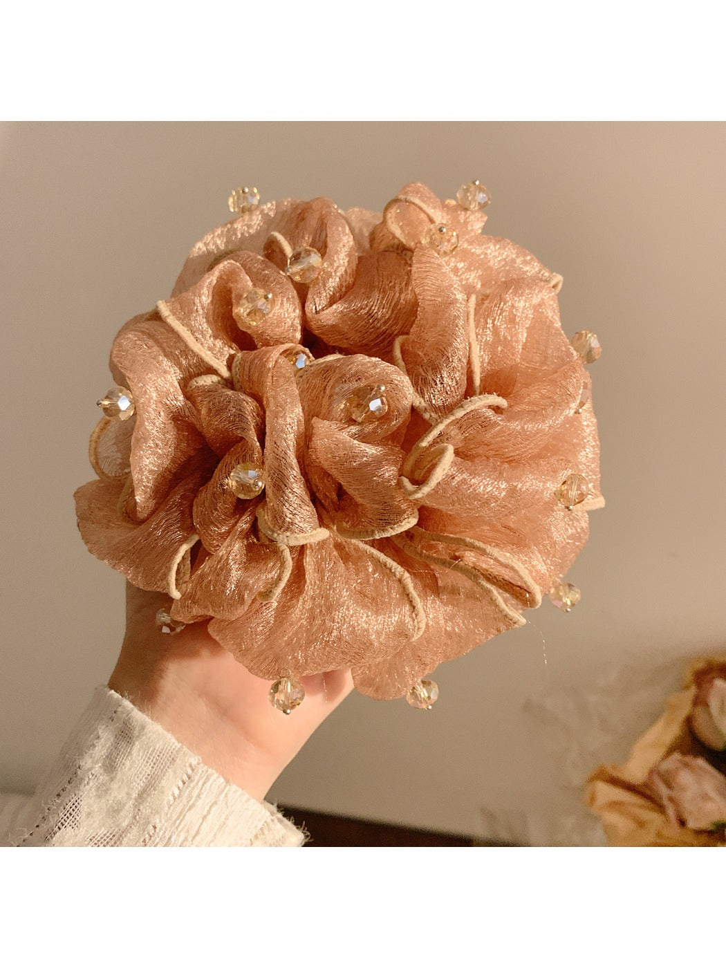 Gifty scrunchie worn on a wrist, showcasing vintage beads and gathered fabric design