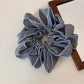 Gifty scrunchie displayed with matching accessories in black and white check