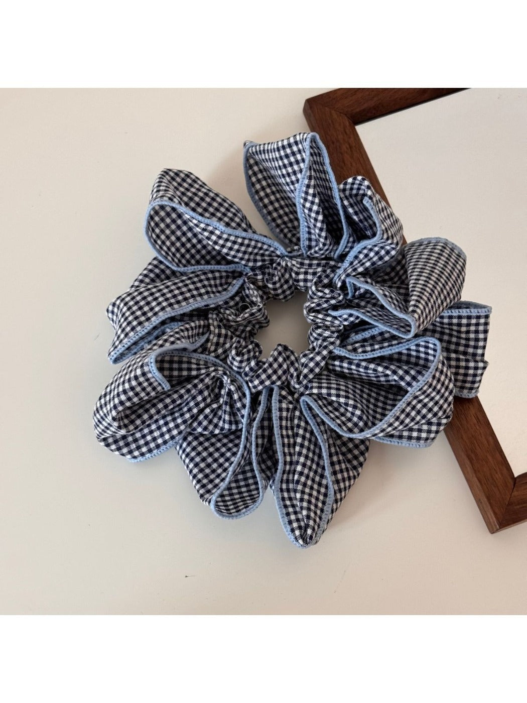 Gifty scrunchie displayed with matching accessories in black and white check