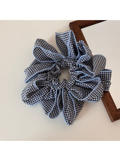 Gifty scrunchie displayed with matching accessories in black and white check