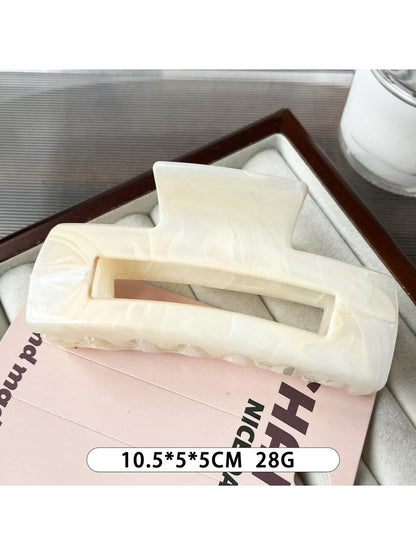 Beau marble pattern square claw clip with light reflecting off its glossy finish