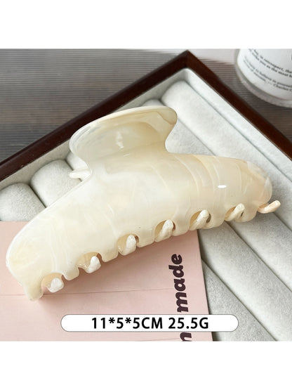 Back view of the Beau plastic updo claw clip in beige on a white background