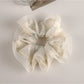 Gifty Sweet Graceful Floral Scrunchie packaged in a clear plastic bag with branding