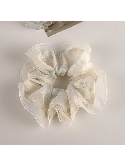 Gifty Sweet Graceful Floral Scrunchie packaged in a clear plastic bag with branding