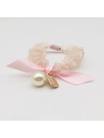 Gifty Sweet Bow Embellished Hair Tie styled in a ponytail on a model with dark hair