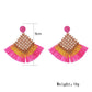 Side view of vintage square raffia drop earrings showing gold-tone hooks and woven raffia