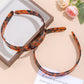 Side view of leopard print headband showing fabric pattern and shape
