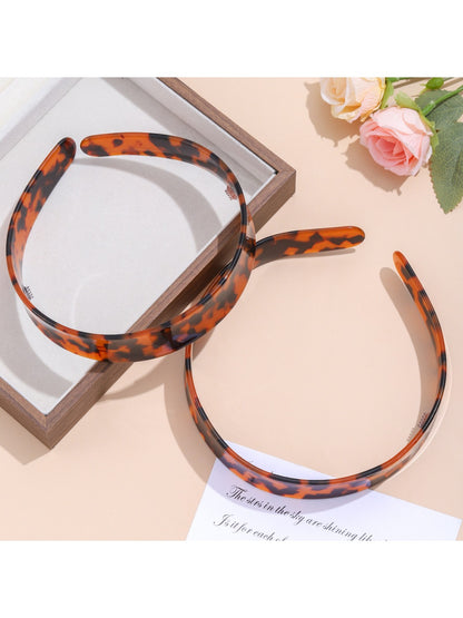 Side view of leopard print headband showing fabric pattern and shape
