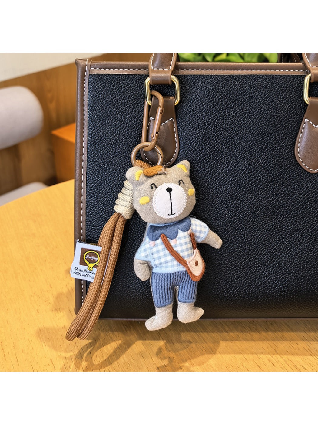 Top view of the bear charm keychain highlighting the gold keyring and clasp