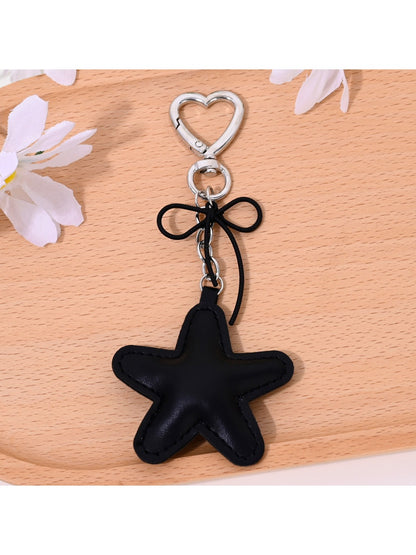 Close-up of gold star keychain showing textured surface and keyring