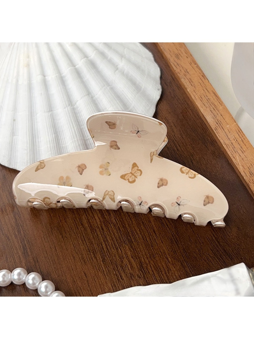 Beau brown butterfly print claw clip with open claws showing teeth detail