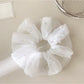 Gifty tulle scrunchie displayed on a white background highlighting its volume