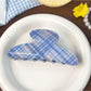 Blue plaid shark hair claw clip with metal spring mechanism visible