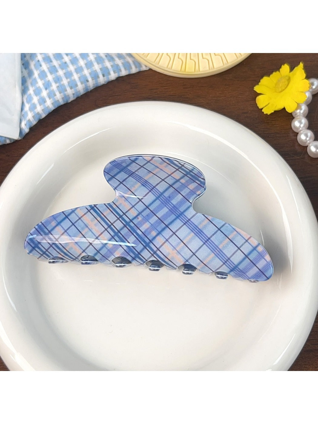 Blue plaid shark hair claw clip with metal spring mechanism visible