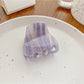 Claw clip open to reveal the inner teeth and spring mechanism