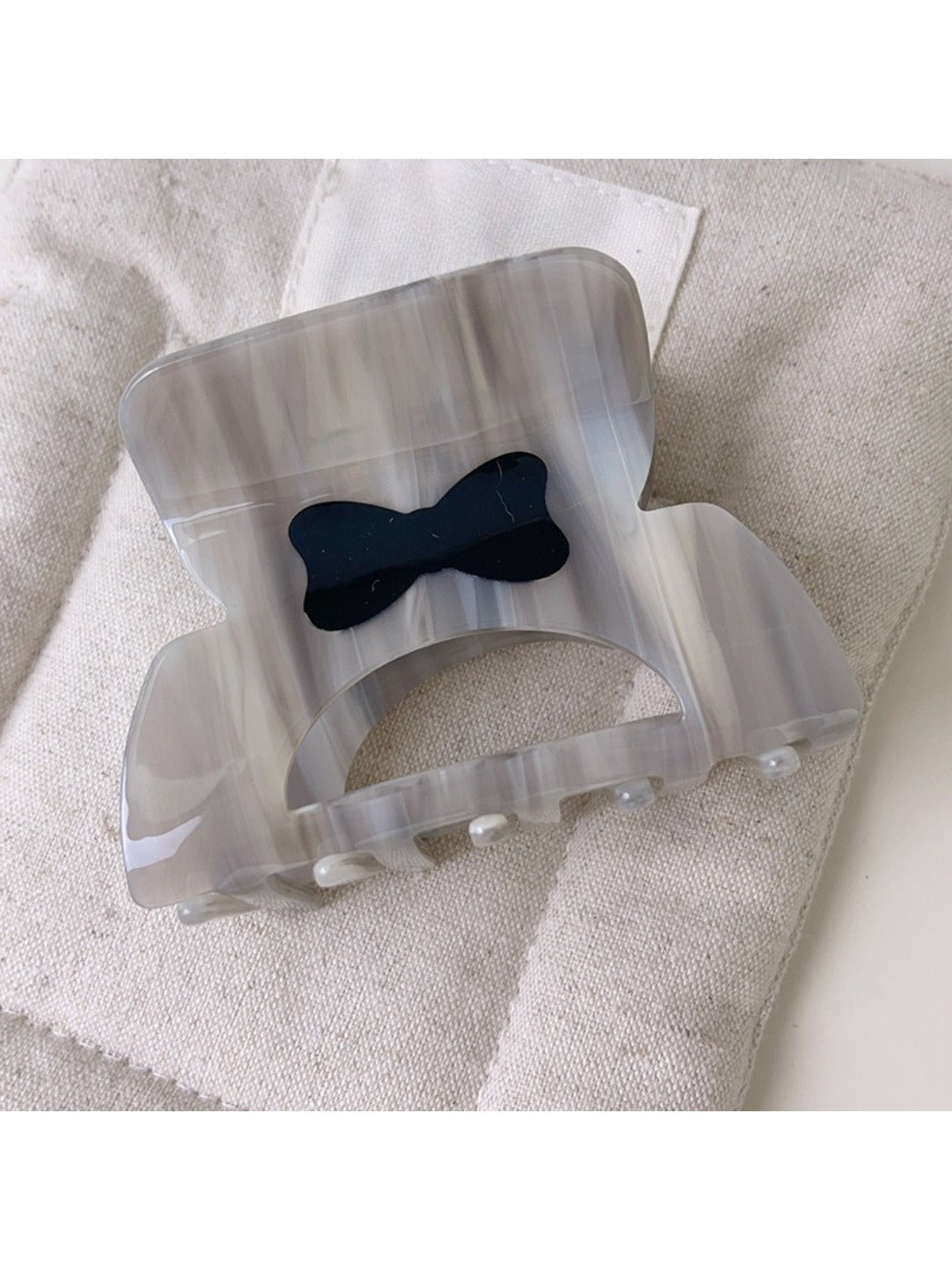 Beau openwork hair claw clip shown from top angle emphasizing symmetrical design