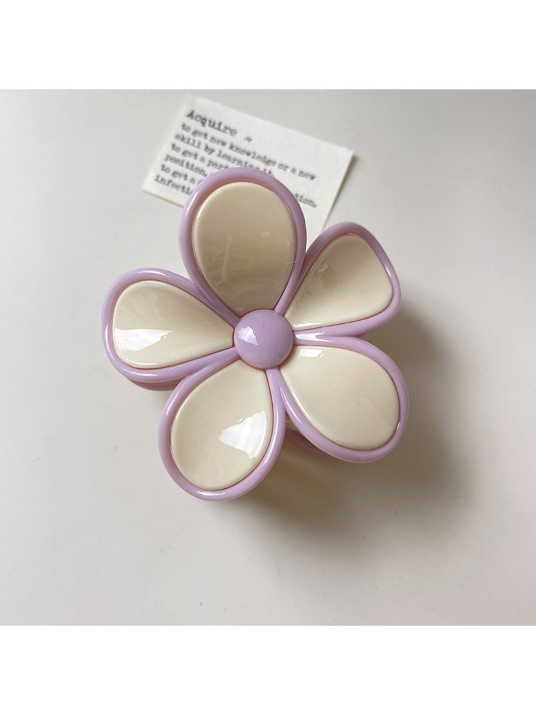 Beau claw clip resting on fabric surface highlighting smooth finish and colors