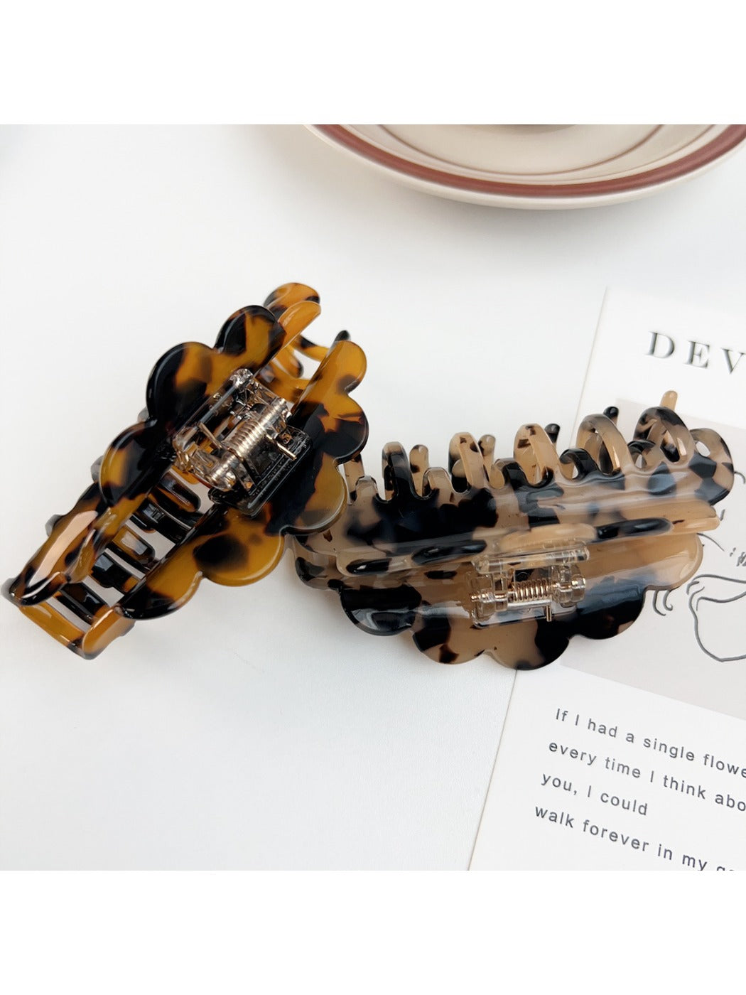 Beau claw clip holding thick brown hair in a half-up hairstyle