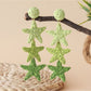 Earedge star pendant earrings styled with casual outfit